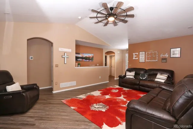 a living room with furniture and wooden floor