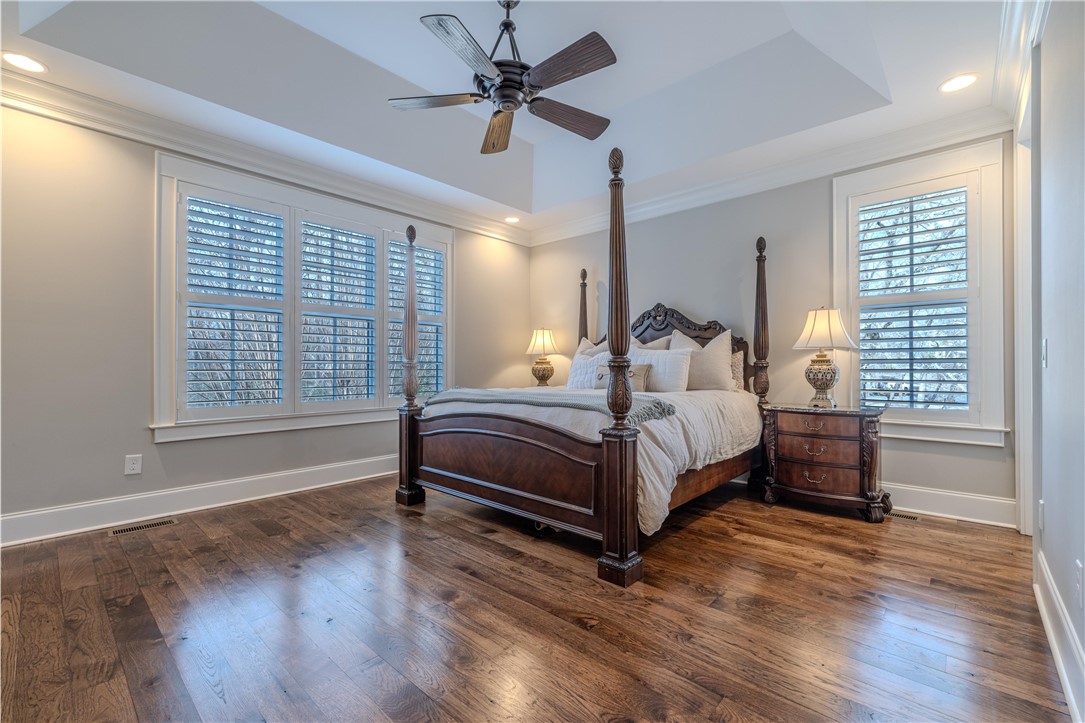 301 Stonebridge Drive Clemson, SC 29631 - Photo 18 of 47 This spacious primary bedroom offers elegant crown molding and rich hardwood flooring.