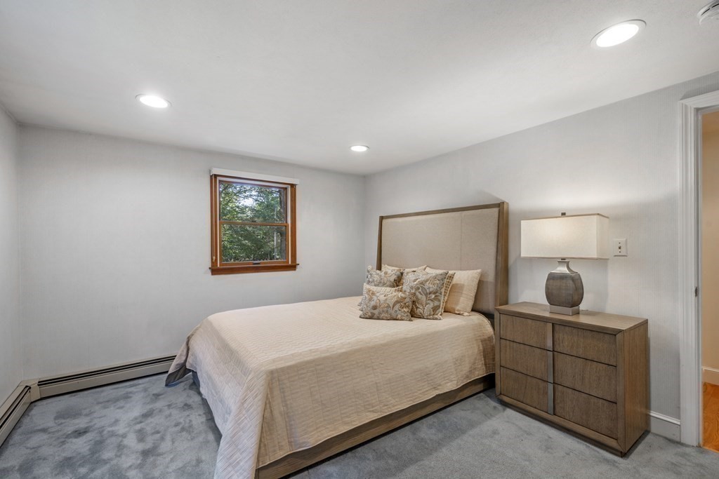 118 Herrick Road Boxford, MA 01921 - Photo 27 of 42 a bedroom with a bed and lamp