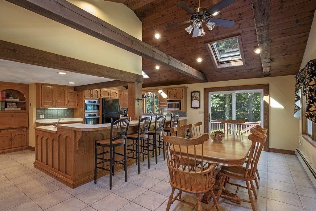 118 Herrick Road Boxford, MA 01921 - Photo 3 of 42 a dining room with furniture a chandelier and fireplace