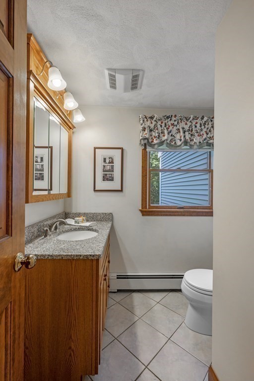 118 Herrick Road Boxford, MA 01921 - Photo 36 of 42 a bathroom with a granite countertop sink mirror vanity and toilet