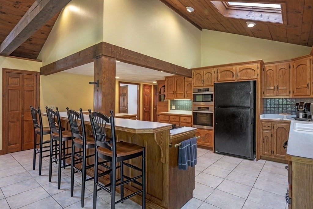 118 Herrick Road Boxford, MA 01921 - Photo 7 of 42 a kitchen with refrigerator and chairs