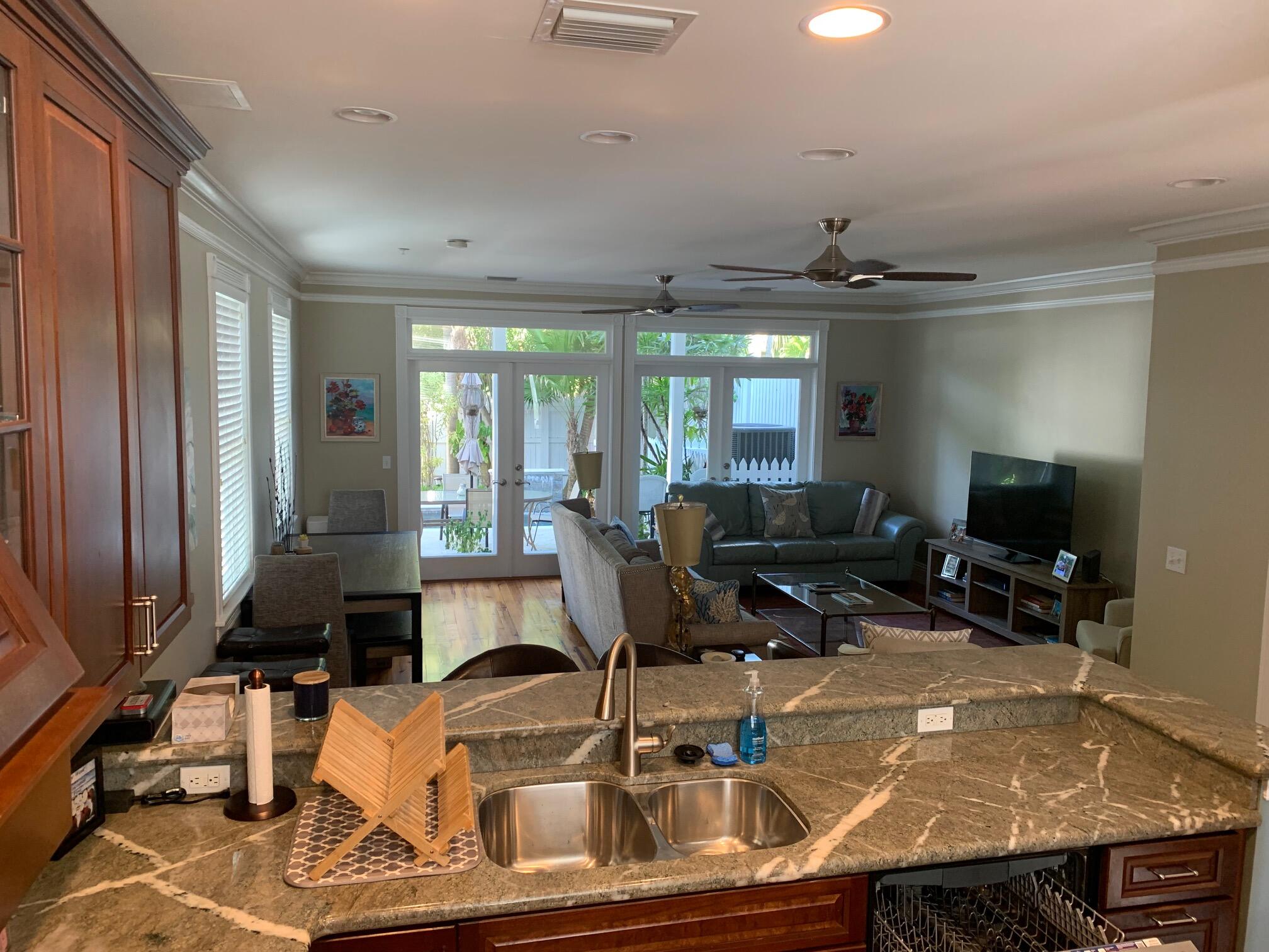 807 Washington Street, Unit 101 Key West, FL 33040 - Photo 11 of 29 a room with furniture and a flat screen tv