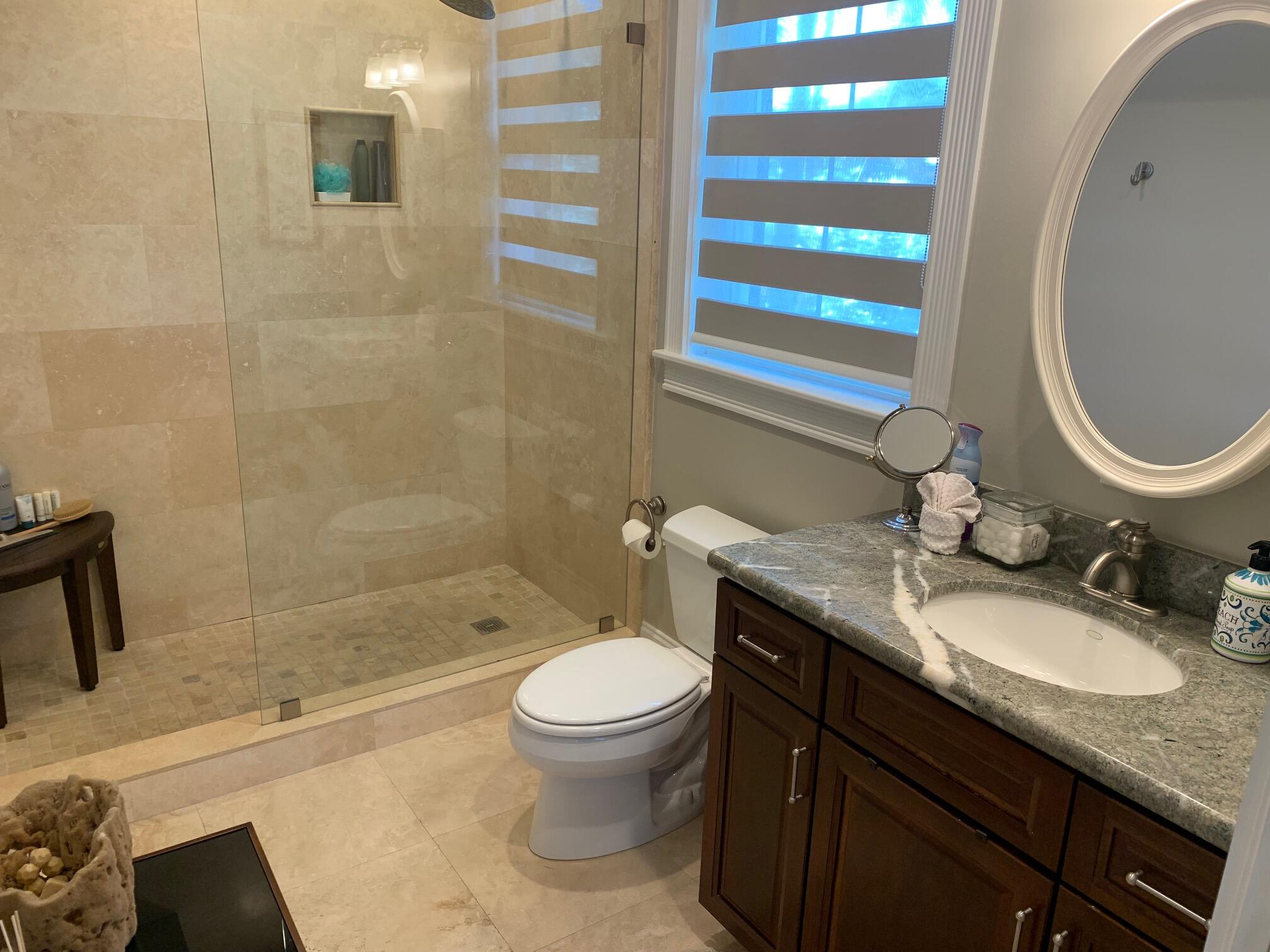 807 Washington Street, Unit 101 Key West, FL 33040 - Photo 17 of 29 a bathroom with a granite countertop toilet a sink and a mirror