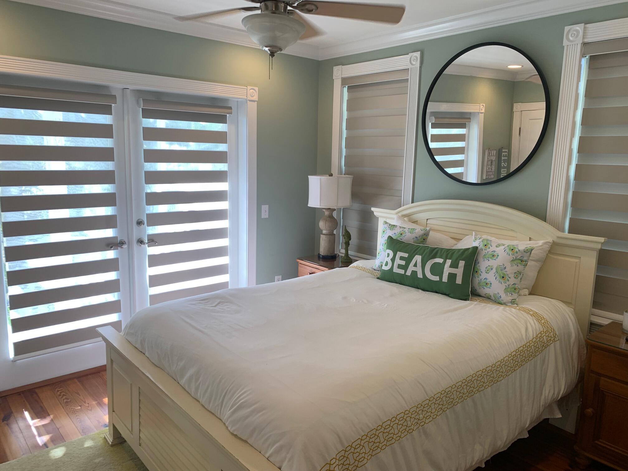807 Washington Street, Unit 101 Key West, FL 33040 - Photo 21 of 29 a bedroom with a bed and a mirror