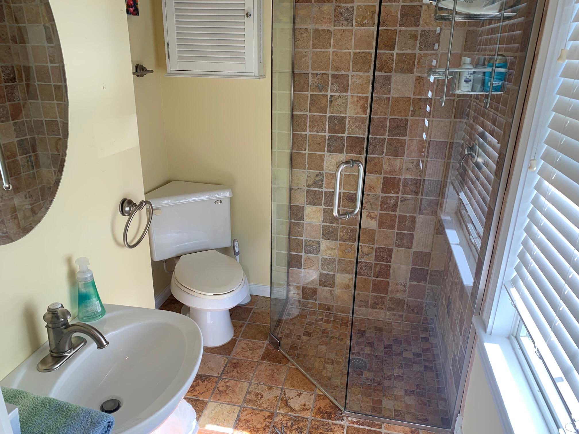 807 Washington Street, Unit 101 Key West, FL 33040 - Photo 22 of 29 a bathroom with a toilet sink and shower
