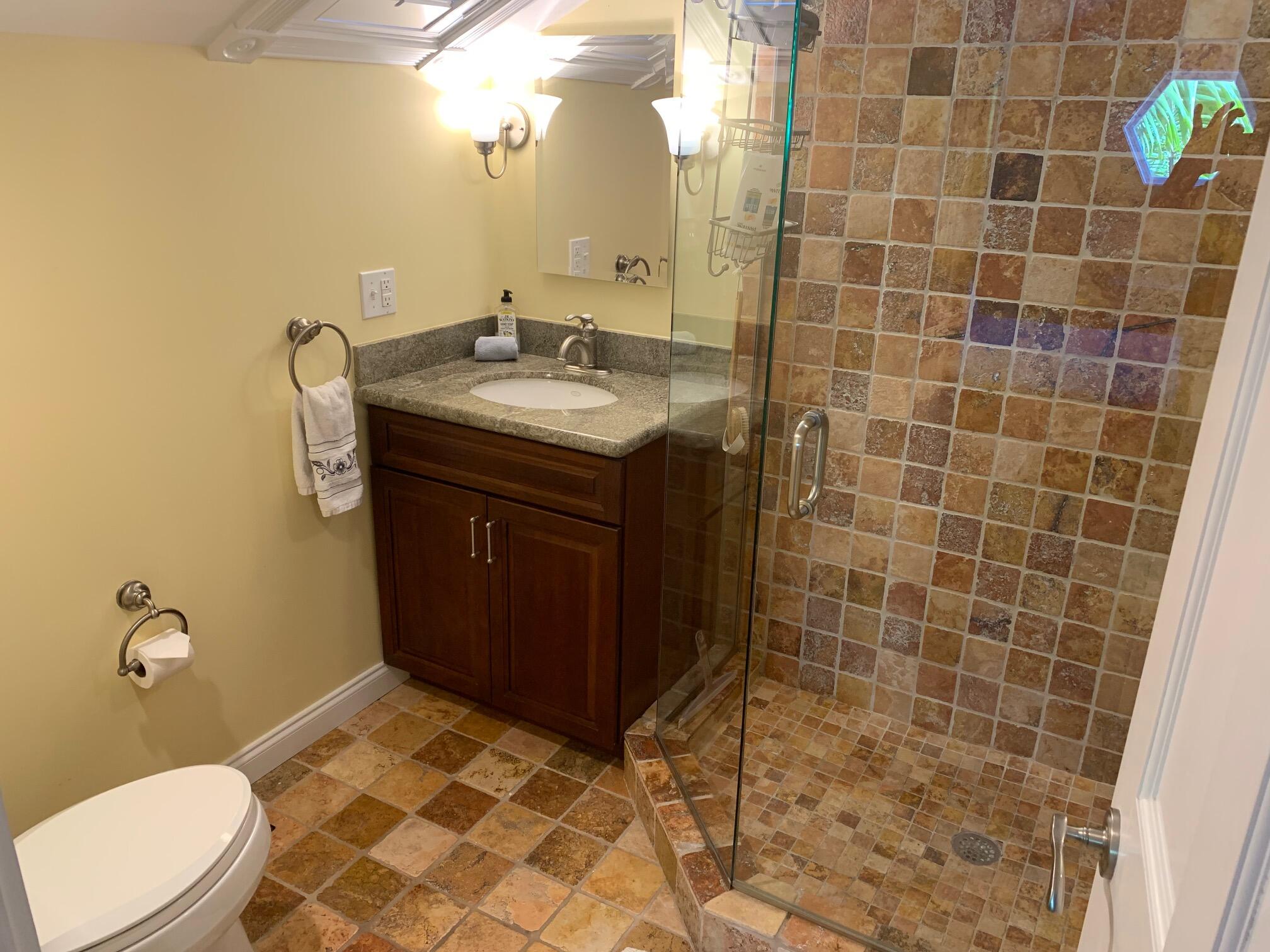 807 Washington Street, Unit 101 Key West, FL 33040 - Photo 26 of 29 a bathroom with a sink vanity and toilet