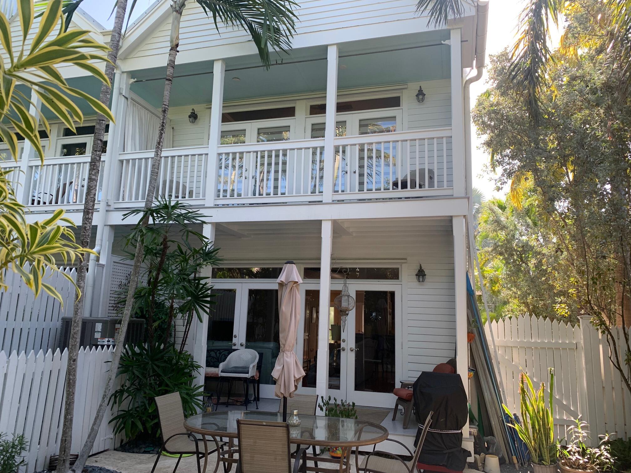 807 Washington Street, Unit 101 Key West, FL 33040 - Photo 3 of 29 a view of a house with backyard and sitting area