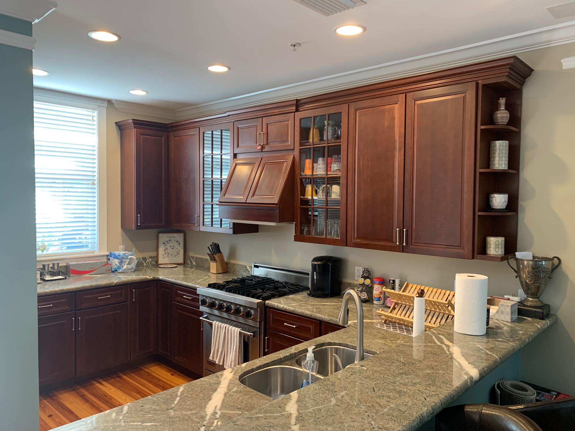 807 Washington Street, Unit 101 Key West, FL 33040 - Photo 5 of 29 a kitchen with stainless steel appliances granite countertop a sink and a stove