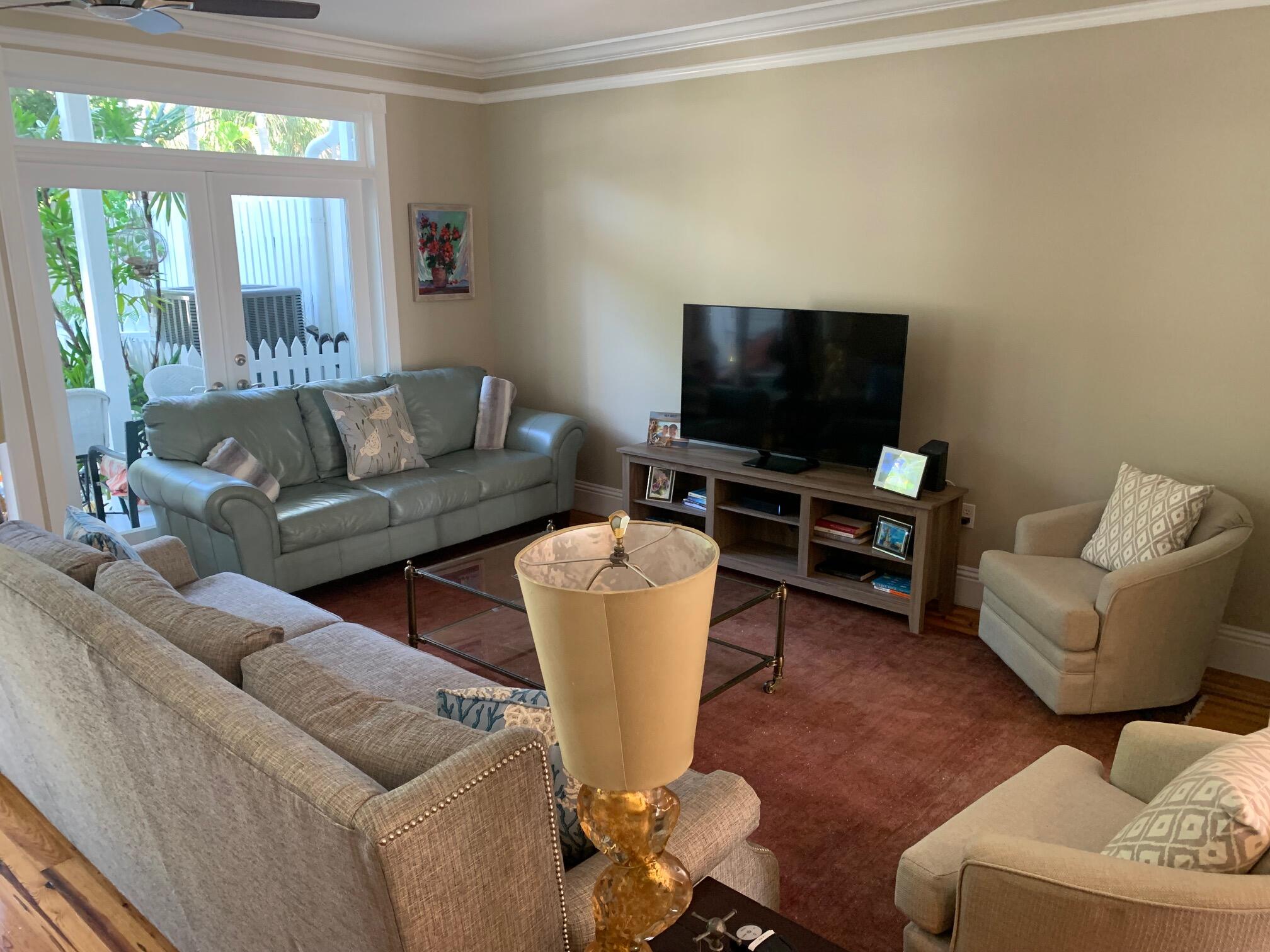 807 Washington Street, Unit 101 Key West, FL 33040 - Photo 8 of 29 a living room with furniture and a flat screen tv