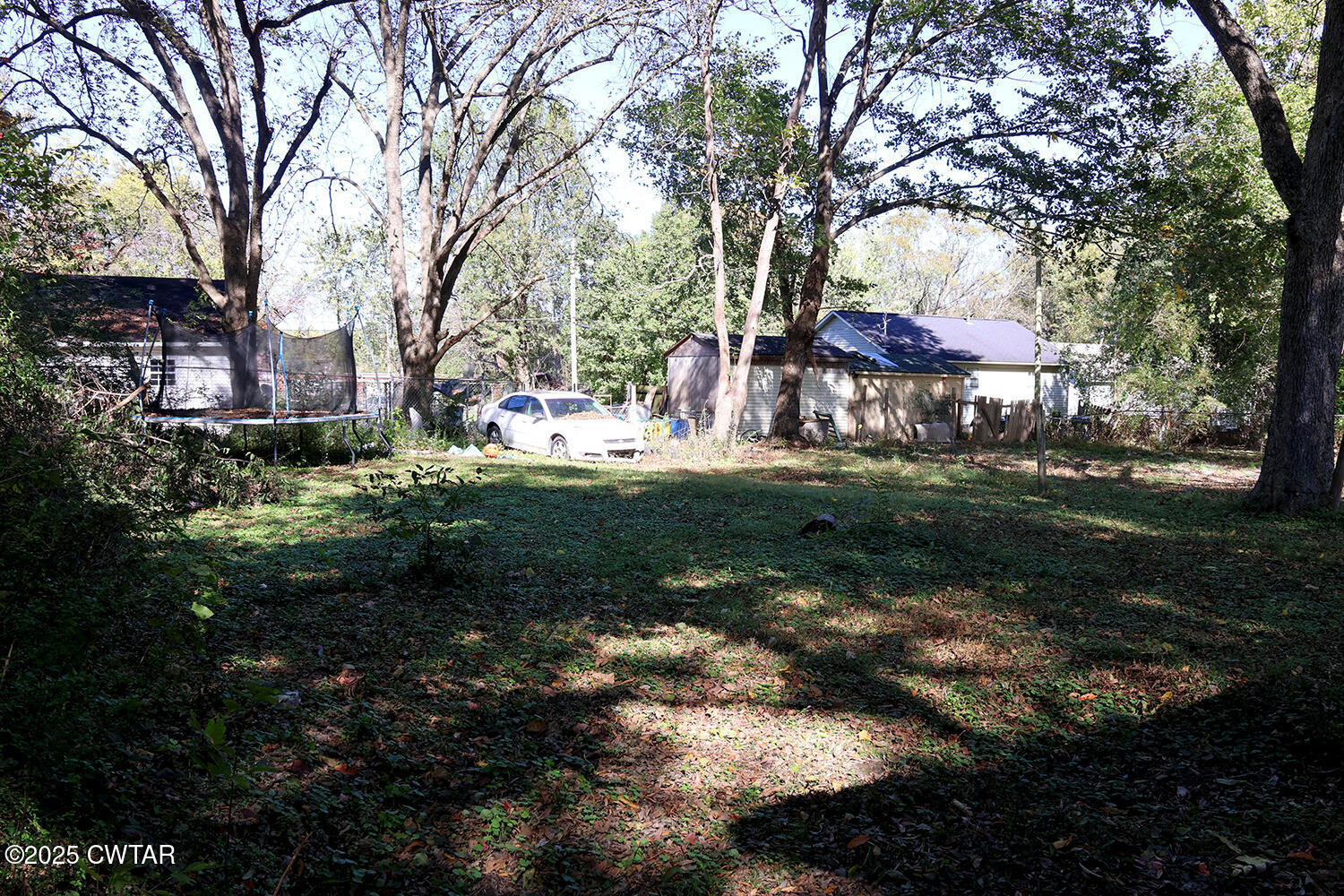 533 East 3rd Street Trenton, TN 38382 - Photo 11 of 12 a backyard of a house with a garden and outdoor seating