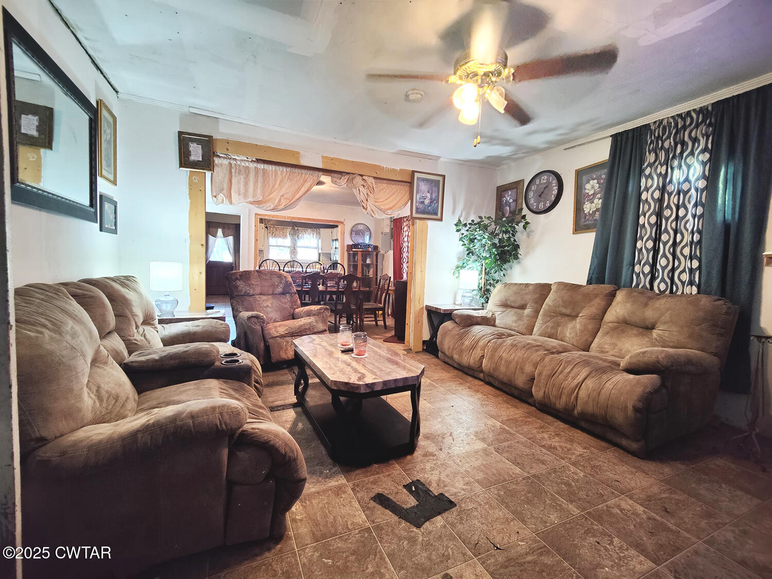 533 East 3rd Street Trenton, TN 38382 - Photo 2 of 12 a living room with furniture ceiling fan and a large window