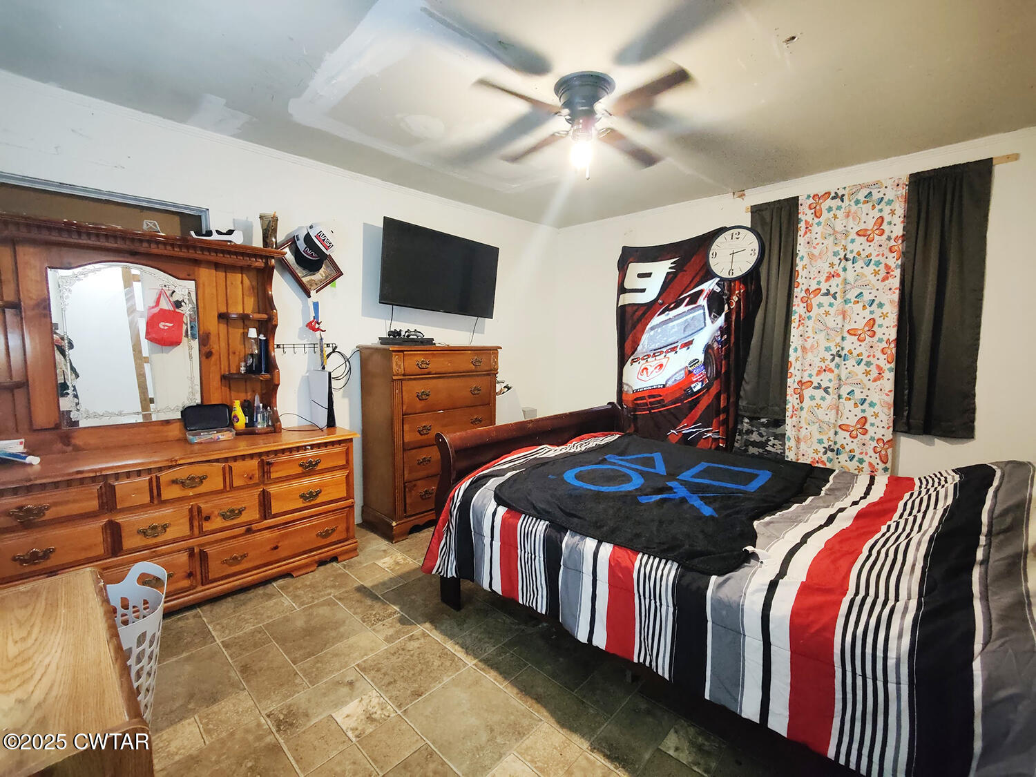 533 East 3rd Street Trenton, TN 38382 - Photo 9 of 12 a bedroom with furniture and a flat screen tv