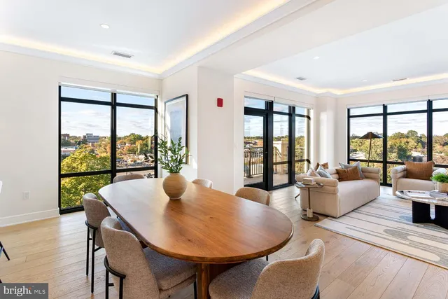 a kitchen with stainless steel appliances white cabinets and wooden floors