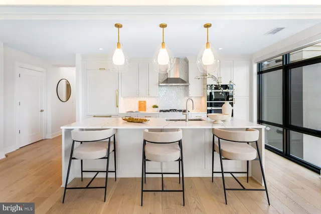 a kitchen with stainless steel appliances white cabinets and stove