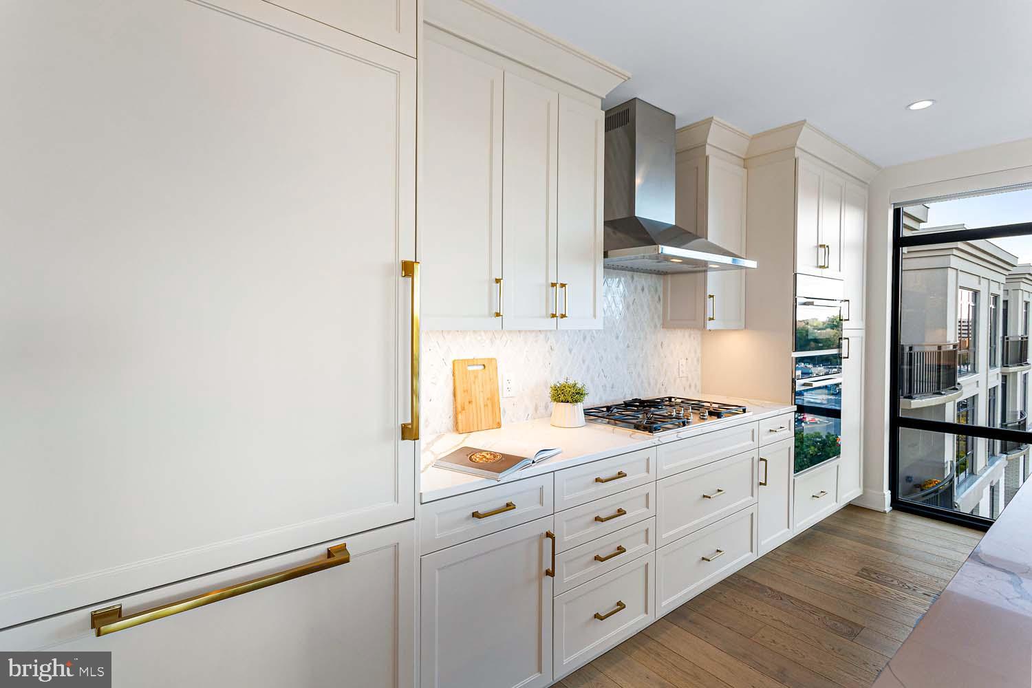 6718 Lowell Avenue, Unit 702 McLean, VA 22101 - Photo 13 of 75 a kitchen with stainless steel appliances white cabinets and wooden floors