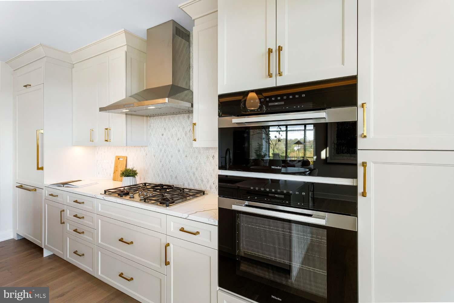 6718 Lowell Avenue, Unit 702 McLean, VA 22101 - Photo 14 of 75 a kitchen with stainless steel appliances white cabinets and stove