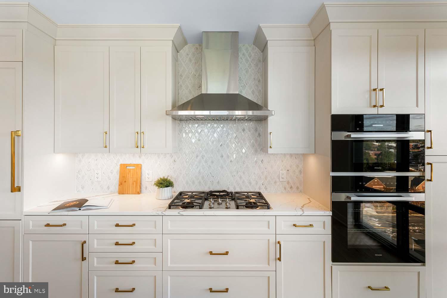 6718 Lowell Avenue, Unit 702 McLean, VA 22101 - Photo 16 of 75 a kitchen with granite countertop white cabinets and stainless steel appliances
