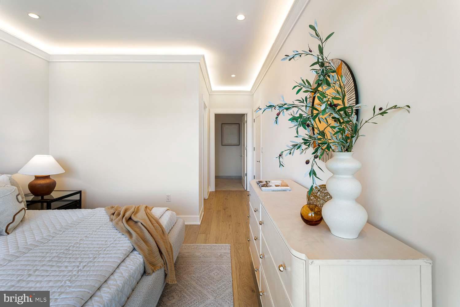 6718 Lowell Avenue, Unit 702 McLean, VA 22101 - Photo 22 of 75 a bedroom with a bed and a chandelier