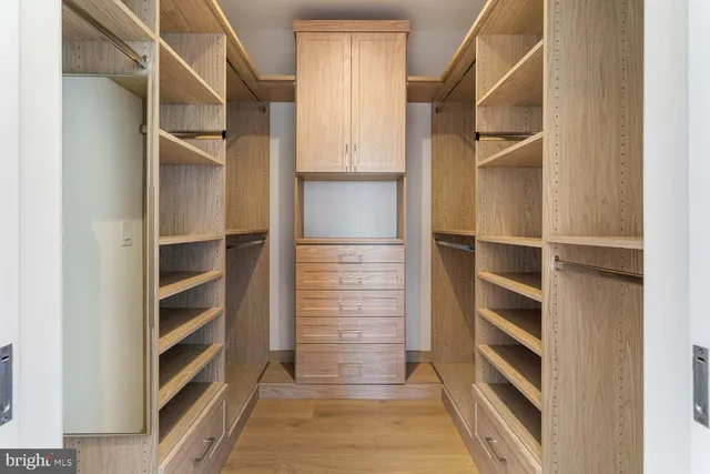 a spacious bathroom with a double vanity sink toilet and mirror