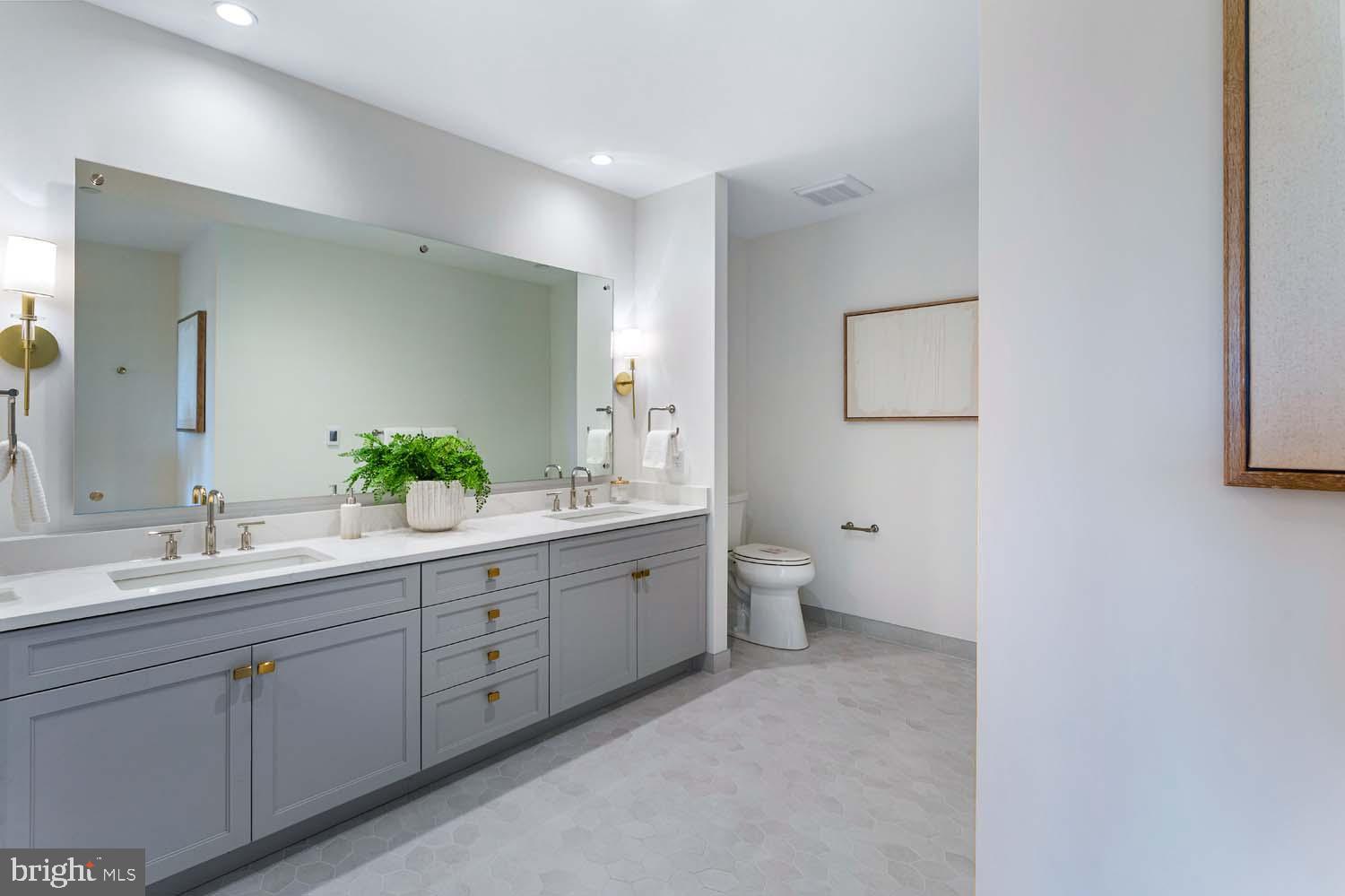6718 Lowell Avenue, Unit 702 McLean, VA 22101 - Photo 25 of 75 a spacious bathroom with a double vanity sink toilet and mirror