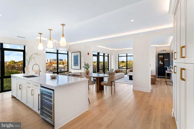 a living room with furniture and a view of kitchen