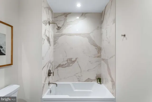 a kitchen with stainless steel appliances granite countertop a sink a stove and a wooden floors