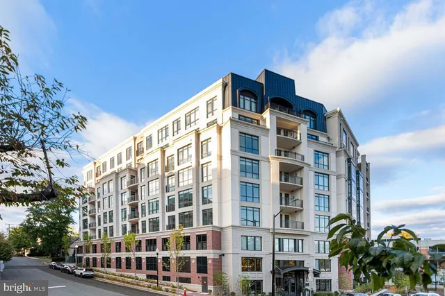 a living room with fireplace furniture and a large window