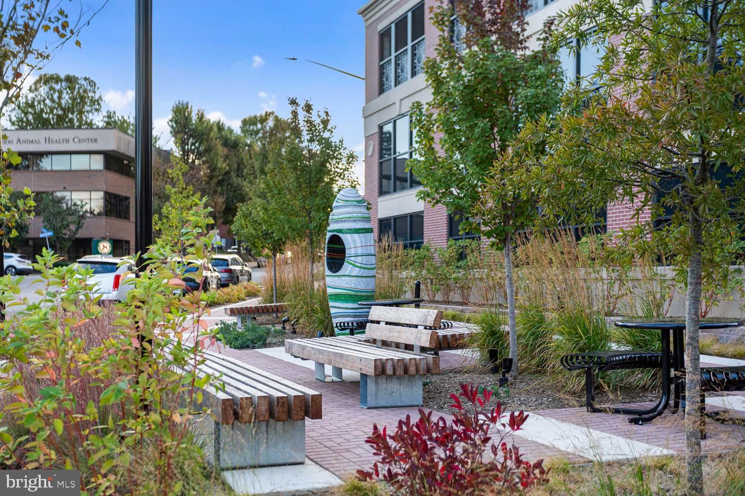 6718 Lowell Avenue, Unit 702 McLean, VA 22101 - Photo 55 of 75 a view of a patio with table and chairs potted plants and large tree