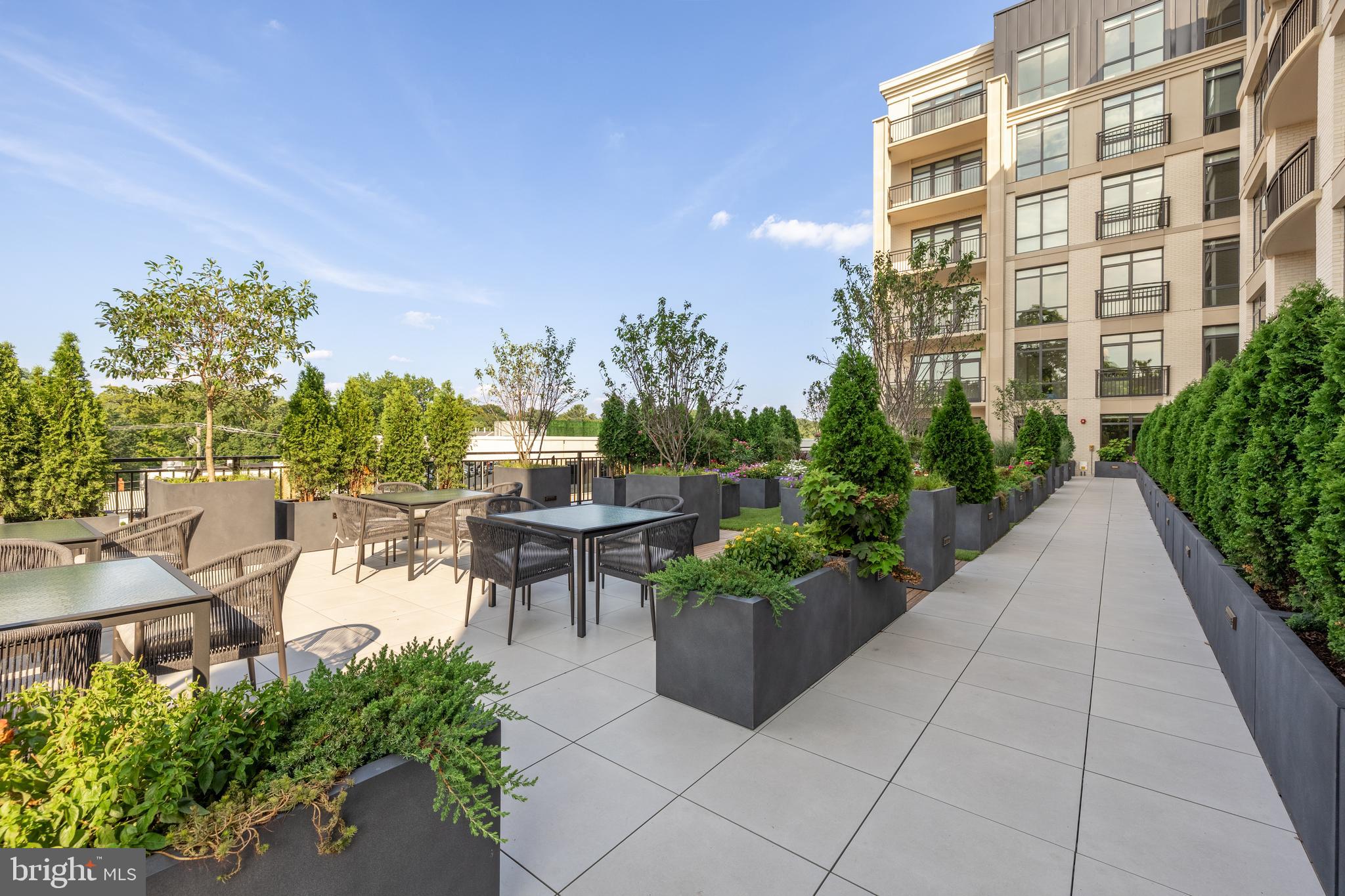 6718 Lowell Avenue, Unit 702 McLean, VA 22101 - Photo 59 of 75 a view of a patio with a table and chairs and potted plants