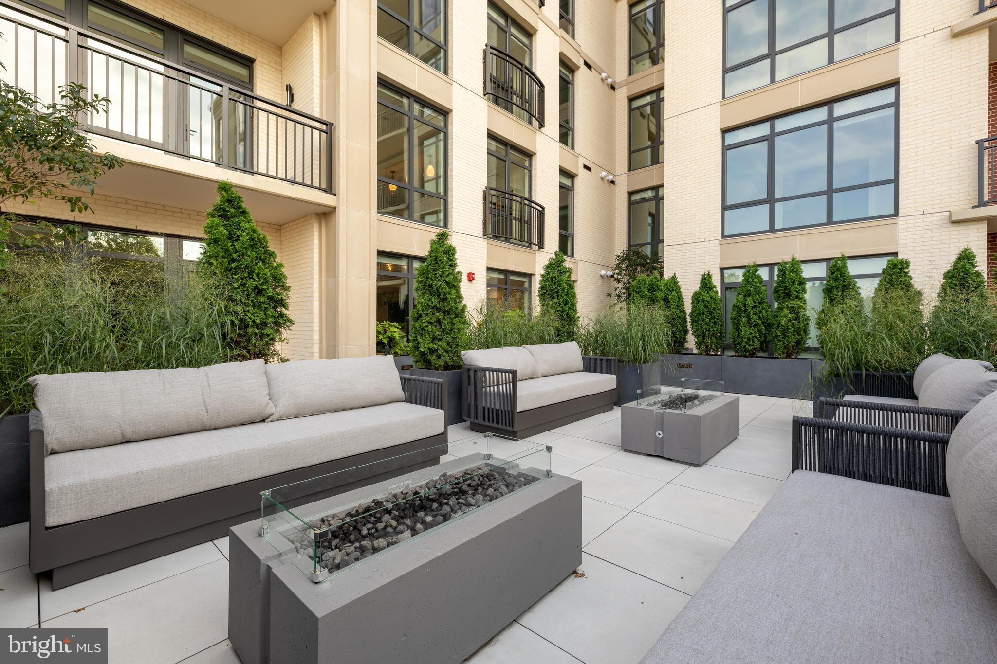 6718 Lowell Avenue, Unit 702 McLean, VA 22101 - Photo 67 of 75 a view of a patio with couches and potted plants