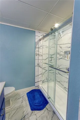 a bathroom with a shower and a sink
