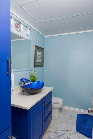 a bathroom with a sink mirror and toilet