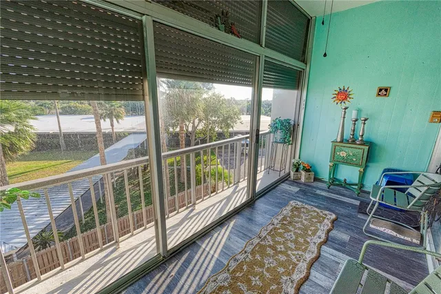 a view of a porch with wooden floor