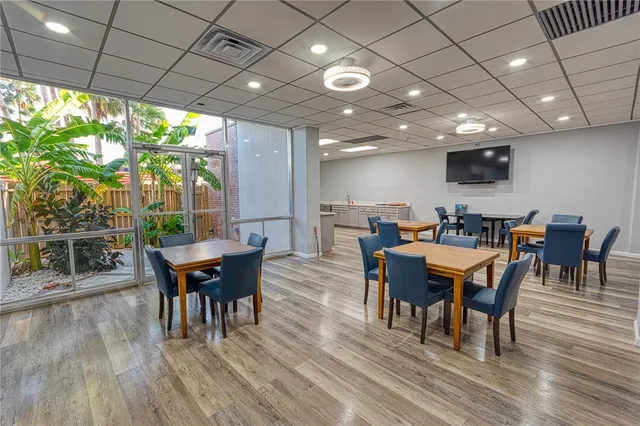 a view of a dining room with furniture window and wooden floor