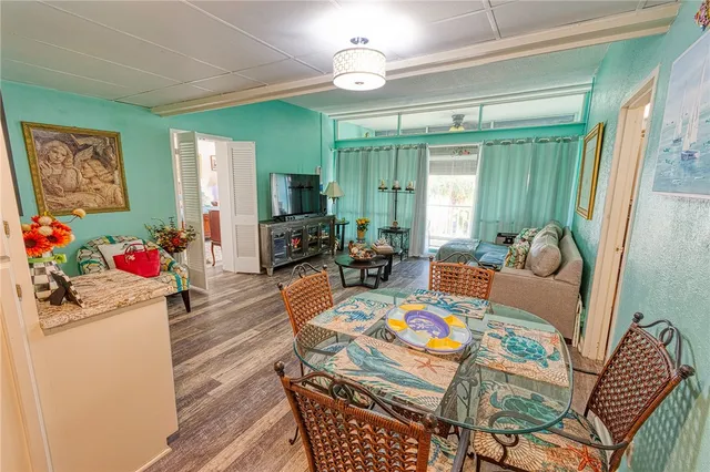 a living room with furniture dining table and a window