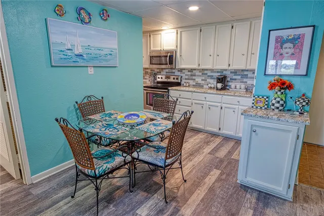 a kitchen with stainless steel appliances kitchen island granite countertop a sink and cabinets