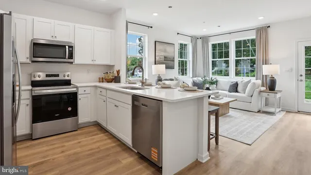 a kitchen with a stove a sink and a microwave