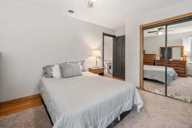 a bedroom with a bed and large mirror