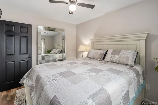 a bedroom with a large bed and a chandelier