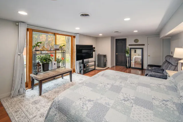 a bedroom with furniture and a flat screen tv