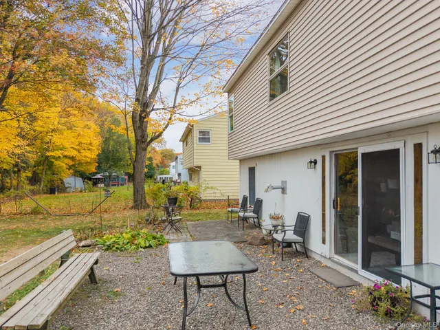 a backyard of a house with outdoor seating