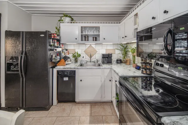a kitchen with stainless steel appliances granite countertop a refrigerator and a stove