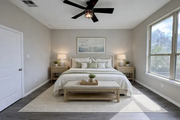 a bedroom with a bed a window and couch