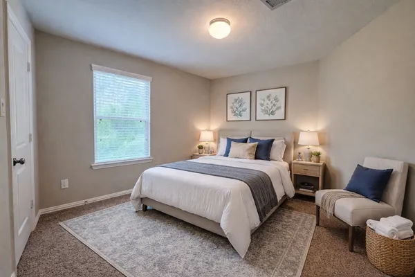 a bedroom with bed and a window