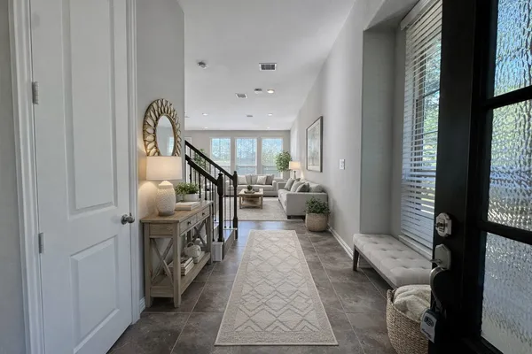 a living room with furniture and stairs