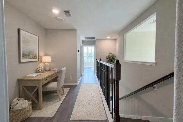 a hallway with a table and chairs