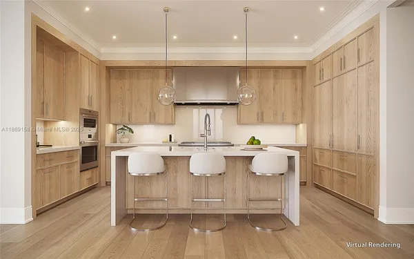 a kitchen with kitchen island white cabinets and stainless steel appliances