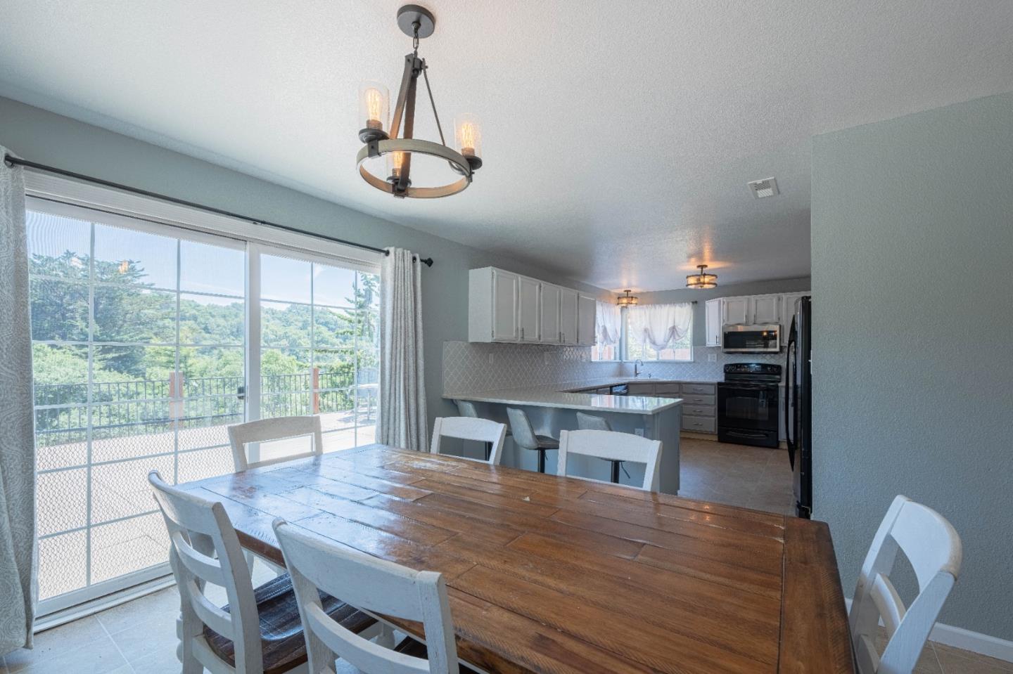 143 Tucker Road Watsonville, CA 95076 - Photo 13 of 42 a kitchen with a table chairs stainless steel appliances and cabinets