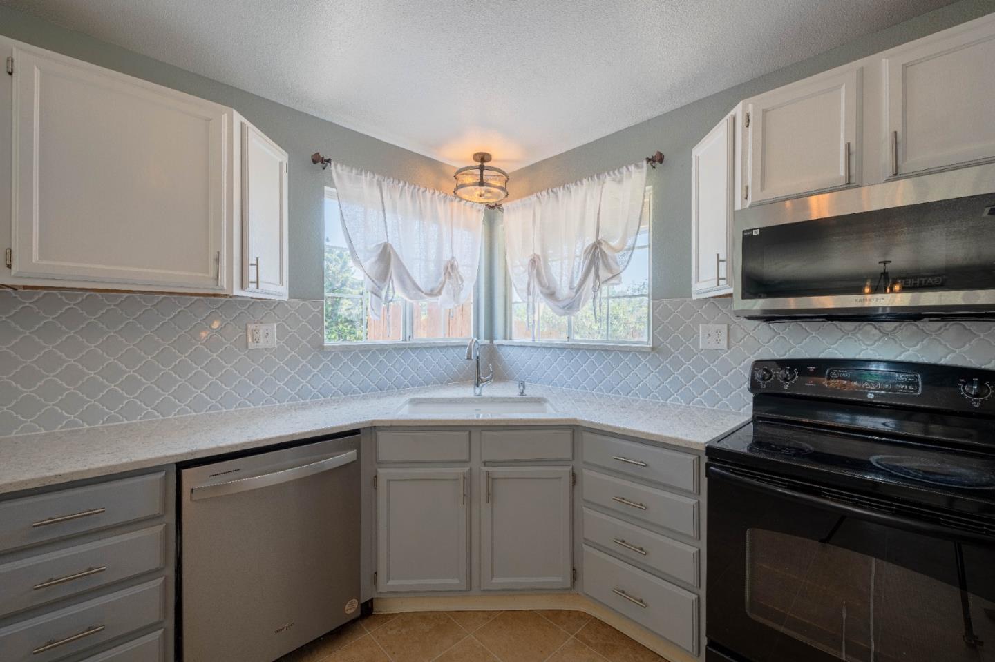 143 Tucker Road Watsonville, CA 95076 - Photo 15 of 42 a kitchen with a sink stove and microwave